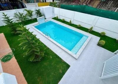 Backyard swimming pool with landscaped garden