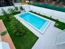 Backyard swimming pool with landscaped garden