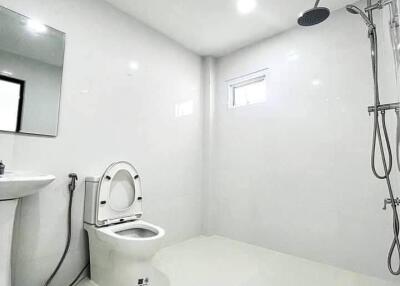 modern bathroom with shower, sink, and toilet