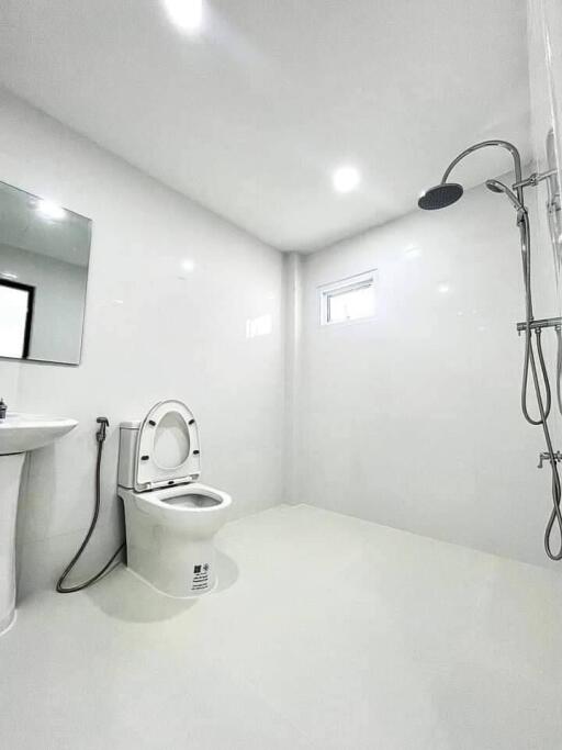 modern bathroom with shower, sink, and toilet