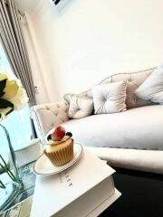 Living room with white couch and decorative pillows