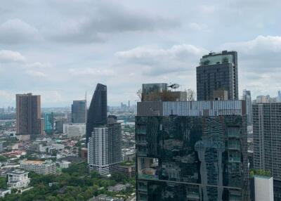 Highrise buildings in a cityscape with a view of a cloudy sky