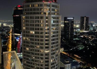 Night view of a high-rise building from a balcony