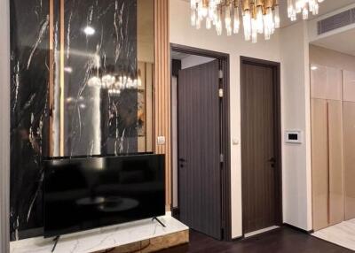 Modern living room with TV and chandelier