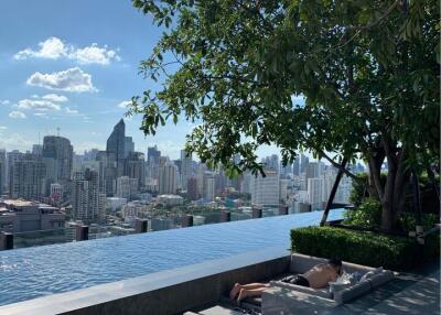 Rooftop pool area with city skyline view