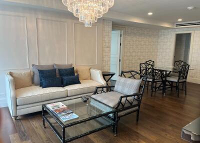 Spacious living room with modern furniture and a chandelier