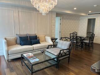 Spacious living room with modern furniture and a chandelier