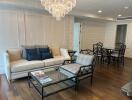 Spacious living room with modern furniture and a chandelier