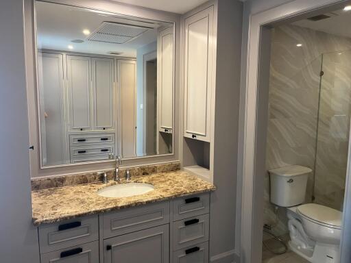 Modern bathroom with marble countertop and shower