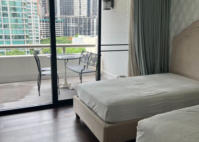 Bedroom with two beds and balcony view