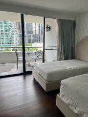 Bedroom with two beds and balcony view