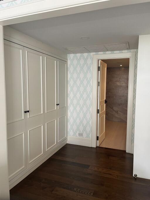 Bedroom with closet and open bathroom door