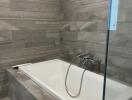 Modern bathroom with bathtub and tiled walls