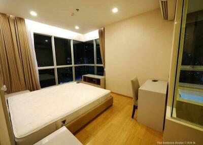 Modern bedroom with large windows and night view