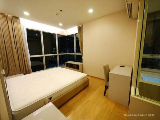 Modern bedroom with large windows and night view