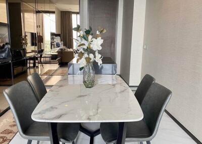 Modern dining area with marble table and four chairs