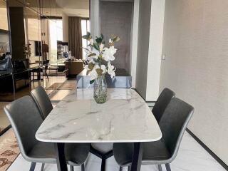 Modern dining area with marble table and four chairs