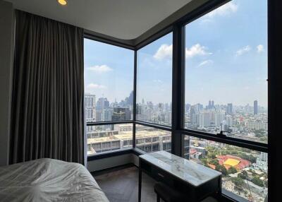 Bedroom with large windows offering a city view