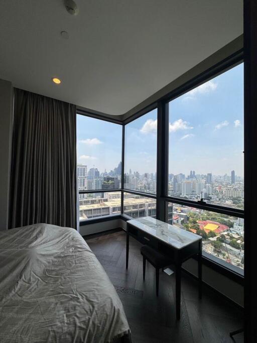 Bedroom with large windows offering a city view