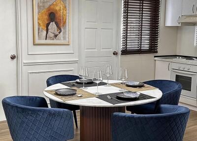 Modern dining area with round table and chandelier