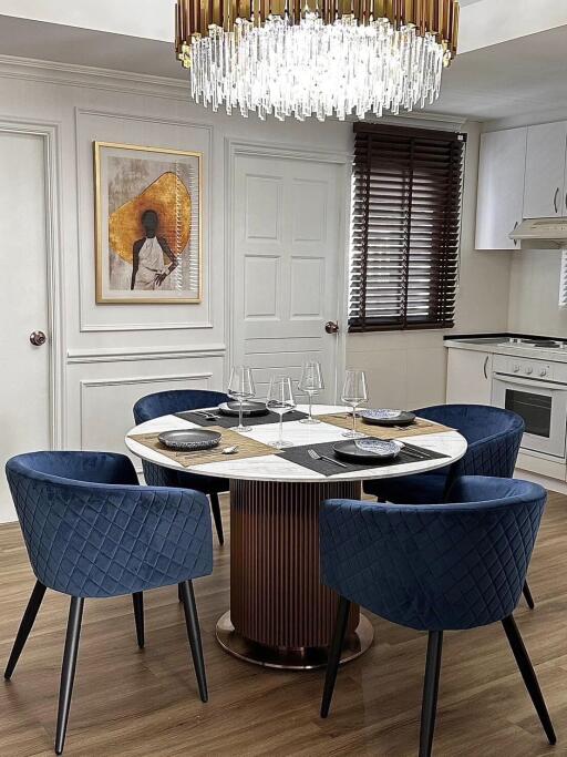 Modern dining area with round table and chandelier