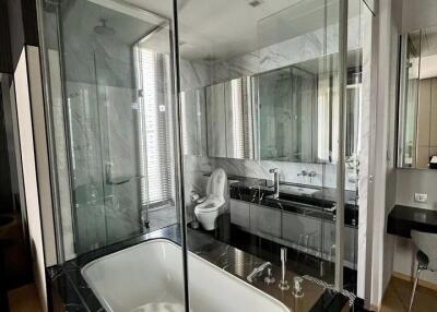 Modern bathroom with glass-enclosed bathtub and shower