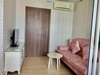 Cozy living room with air conditioner, sofa, TV, and a coffee table