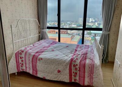 Bedroom with large window and city view