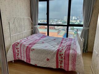 Bedroom with large window and city view