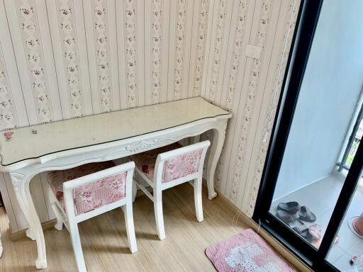 Bedroom with vintage desk and chairs next to window