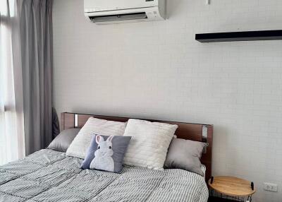 Cozy modern bedroom with bed and air conditioning