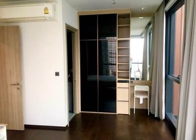 Spacious bedroom with large wardrobe and natural lighting