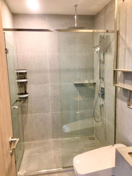 Modern bathroom with glass shower enclosure and tiled walls