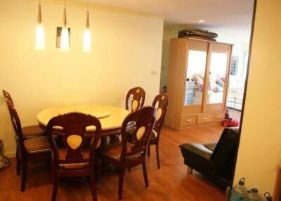 Dining room with wooden furniture and overhead lighting