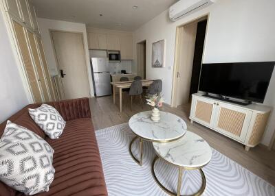 Living room with modern furniture including a sofa, TV, and coffee tables