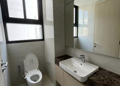 Modern bathroom with large mirror and window