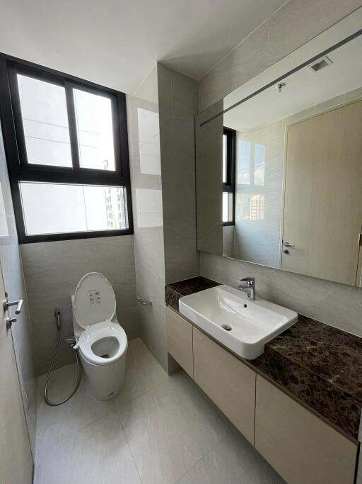 Modern bathroom with large mirror and window