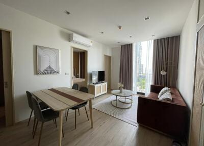 Modern living room with dining area and large window