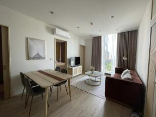 Modern living room with dining area and large window