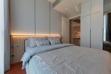 Modern bedroom with a cozy bed and soft lighting