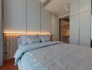 Modern bedroom with a cozy bed and soft lighting