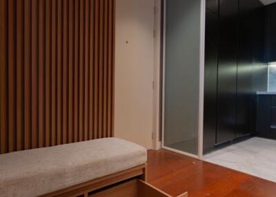 modern hallway with wooden accents and storage bench