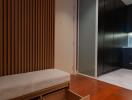 modern hallway with wooden accents and storage bench