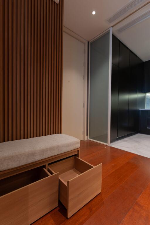 modern hallway with wooden accents and storage bench