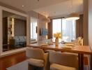 Modern dining room with a wooden table and elegant chairs, featuring a large mirror and open living space.