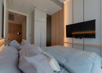 Modern bedroom with TV and storage units