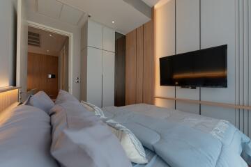 Modern bedroom with TV and storage units