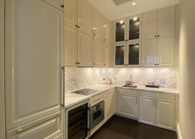 Modern kitchen with white cabinets and dark wood flooring