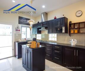 Modern kitchen with dark cabinets and central island