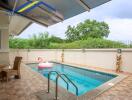 Outdoor area with swimming pool, seating, and greenery